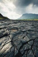Majestic volcanic landscape showing cracked lava rock under cloudy skies photo