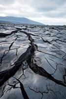 Cracked volcanic landscape formed by recent lava flow in a remote location photo
