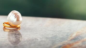 Elegant pearl ring resting on a polished marble surface, with a blurred green background photo