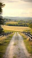 Dirt road winding through a scenic countryside landscape with fields photo