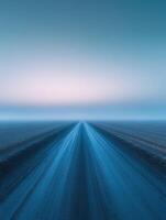 Dirt road stretching into the horizon at twilight under a serene sky photo