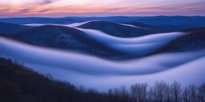 Fog envelops valley at sunrise in winter photo