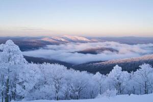 Winter landscape with mountains and fog photo