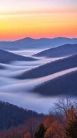 Majestic sunrise over rolling misty mountains photo