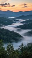 Misty mountains at sunrise in the valley photo