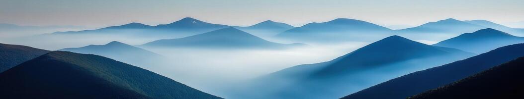 Morning mist blankets mountain range photo