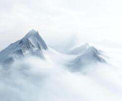 Snowy mountain peaks emerging from fog photo