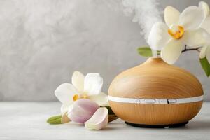 Aroma oil diffuser releasing calming steam into air with spring flowers photo