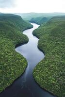 Serene river winding through lush green valleys photo