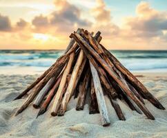 Campfire setup on a sandy beach at sunset photo