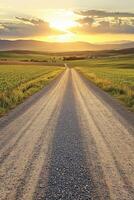 Sunset over a winding gravel road photo