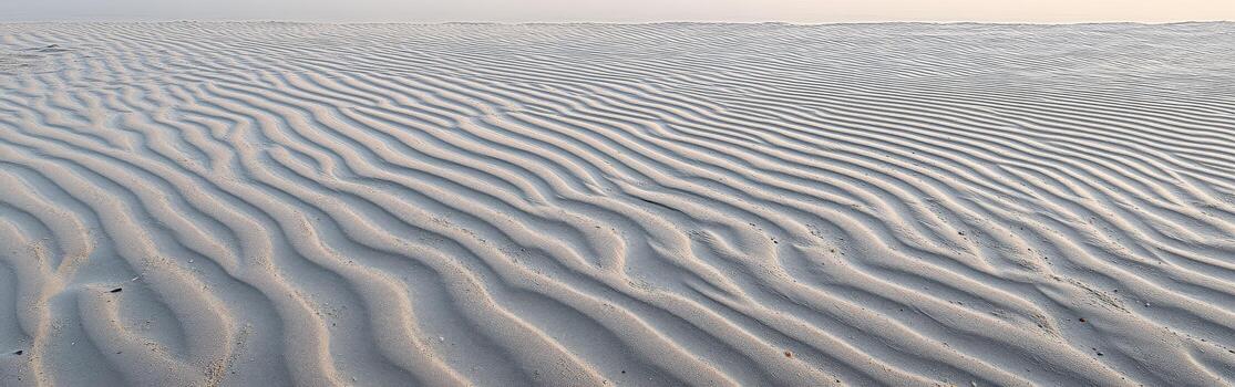 A man is walking on a beach with a surfboard photo