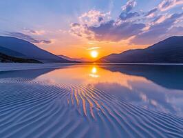 A sunset over a lake with ripples in the water photo