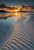 Sunset at the beach with waves and sand photo