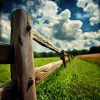 A wooden fence in a field with a sky background photo