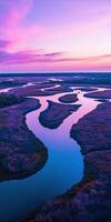 A purple sky and a river in the marsh photo