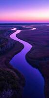 A river runs through a marsh at sunset photo