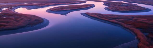 An aerial view of a river and marsh at sunset photo