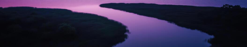 A purple sky and a river in the middle of a lake photo
