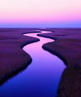A river runs through a marsh at sunset photo