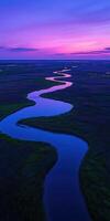 A river flowing through a marsh at sunset photo