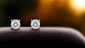 Close-up of sparkling diamond earrings on a soft surface with a blurred sunset background photo