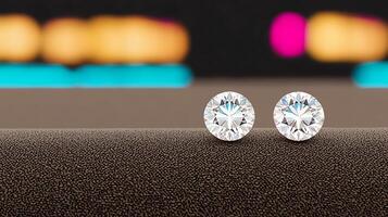 Close-up of two sparkling diamond earrings on a textured surface with blurred colorful background photo