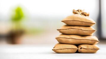 Stack of burlap sacks arranged neatly on a table with a blurred green plant in the background photo