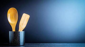 Wooden cooking utensils in a stylish holder against a gradient blue background, ideal for culinary themes photo