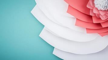 Vibrant layered paper flowers in shades of pink and white against a serene blue background photo