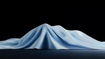 Soft blue fabric draped elegantly, creating a smooth mountain-like shape against a dark backdrop photo