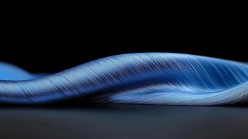 Close-up of a flowing blue fabric draped elegantly against a dark background, showcasing texture photo