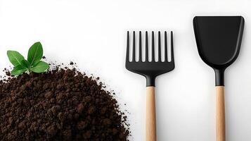 Close-up of gardening tools beside fresh soil and a sprouting plant on a clean surface photo