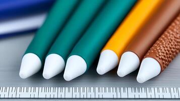 Close-up of colorful pens arranged neatly on a desk with a ruler, showcasing vibrant hues photo