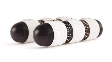 Close-up of three modern camera lenses arranged in a row on a clean white background photo