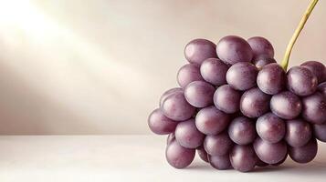 Cluster of ripe purple grapes resting on a smooth surface with soft lighting in the background photo