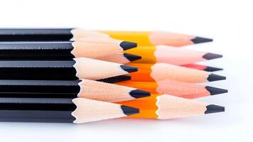 A close-up view of sharpened colored pencils arranged in a row on a white background photo
