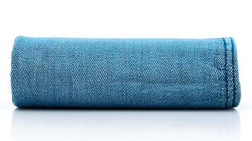 Rolled denim fabric showcasing texture and color, set against a reflective surface photo
