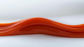 Smooth, flowing red sauce on a white surface, highlighting its glossy texture and color photo