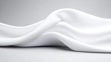 Smooth, flowing white fabric draped elegantly on a soft gray background, creating a serene ambiance photo
