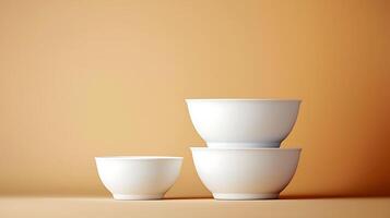 Stacked white bowls on a soft orange background, showcasing minimalistic design and elegance photo