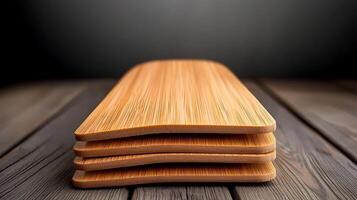 Stacked wooden cutting boards on a rustic wooden table with a soft gradient background photo