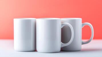 Three blank white mugs arranged on a table with a soft red gradient background photo