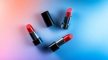 Three vibrant lipsticks in red and pink shades placed artistically on a gradient background photo
