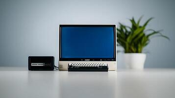 Vintage computer setup featuring a monitor and a retro device on a minimalistic table with greenery photo