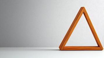 Wooden triangle on a minimalistic white background, symbolizing creativity and design photo