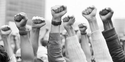 Raised fists in solidarity during a protest, symbolizing unity and strength. photo