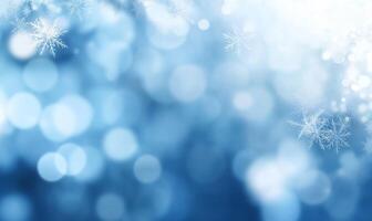 A soft blue background with snowflakes and bokeh effects for winter themes. photo