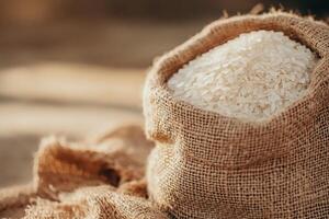 A burlap sack filled with white rice, symbolizing food storage. photo