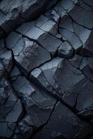 Dark rock face showing cracks and texture forming a natural background photo